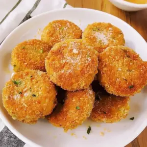 Crispy salmon croquettes served with dipping sauce on a plate