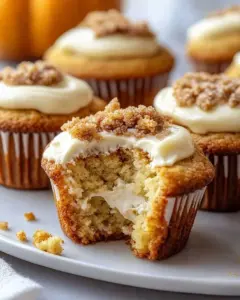 Freshly baked decadent pumpkin muffins topped with spices and walnuts.
