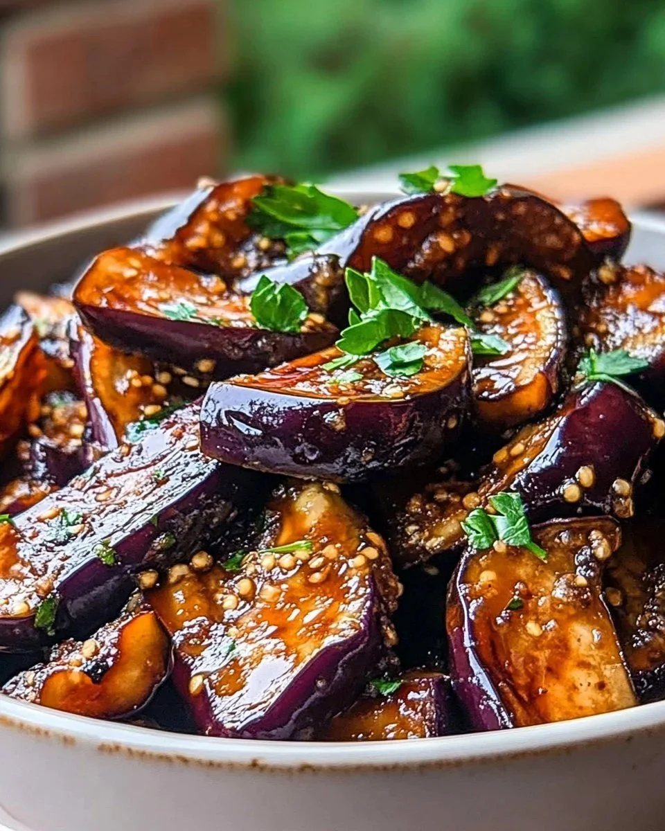 Delicious sticky garlic eggplant dish served on a plate.