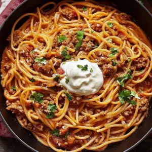 Delicious serving of Taco Spaghetti topped with cheese and cilantro